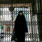 A woman walks past the closed gate of the Imamzadeh Saleh mosque in the Iranian capital Tehran on April 25. On Monday Iran reopened some places of worship in parts of the country deemed at low risk from the coronavirus