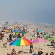 People enjoy the sun and sand amid the novel coronavirus pandemic in Huntington Beach, California