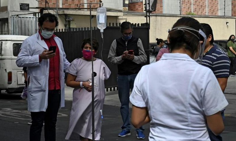 People gather outside a hospital in Mexico City, on June 23, 2020, after a powerful quake rocked the south of the county