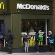 Delivery riders queue  outside a McDonald's in London; the company is facing a sexual harassment complaint filed at the OECD by an international coalition of labor unions