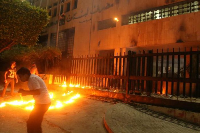 Lebanese protesters throw Molotov cocktails the branch of the central bank in the southern city of Sidon