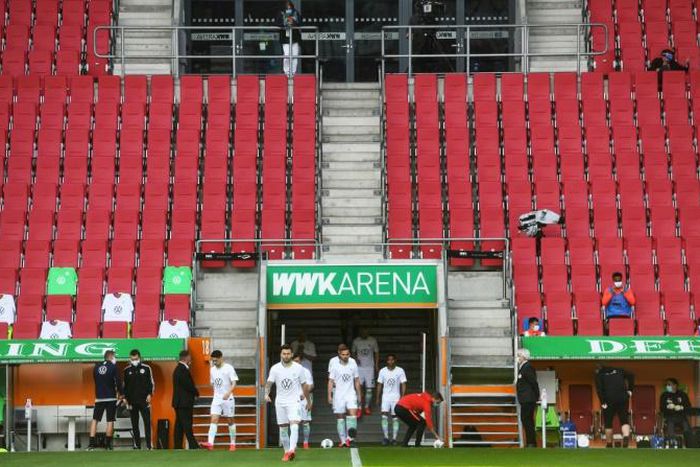 Is there anybody there? Wolfsburg players come onto the pitch prior to their game at Augsburg