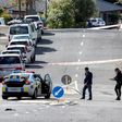 Police officers cordon off an area after the fatal shooting in a residential neighbourhood in Auckland