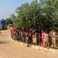 Security personnel use a loudspeaker to raise awareness about the coronavirus in a Rohingya refugee camp in southeast Bangladesh