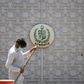 A man sweeps in front of the main gate of the Pakistan High Commission in New Delhi