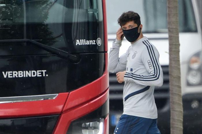 Bayern Munich forward Robert Lewandowski wears a mask as he leaves a training session