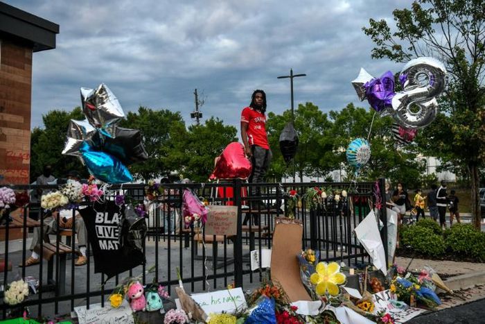 A man stands outside a burned Wendy's restaurant in Atlanta, where police shot dead Rayshard Brooks in the parking lot, setting off protests -- the US is against a possible racism inquiry by the UN Human Rights Council