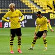 Julian Brandt (C) gives an elbow bump to goal-scorer Thorgan Hazard (L) - complying with hygiene regulations - during Borussia Dortmund's 4-0 thrashing of Schalke.