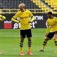 Julian Brandt (C) gives an elbow bump to goal-scorer Thorgan Hazard (L) - complying with hygiene regulations - during Borussia Dortmund's 4-0 thrashing of Schalke.