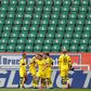Raphael Guerreiro (C) celebrates scoring the opening goal in Borussia Dortmund's 2-0 win at Wolfsburg in a near-empty stadium.
