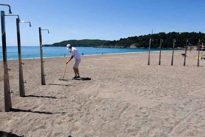 In spite of the absence of tourists the staff have been raking the beaches in Montenegro, preparing for a possible late rush