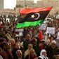 Supporters of Libyan military strongman Khalifa Haftar wave a national flag in a February 2020 demonstration in Benghazi