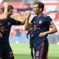 Midfielder Leon Goretzka celebrates with Bayern Munich team-mates Robert Lewandowski (L) and Thomas Mueller in the 4-2 win at Bayer Leverkusen