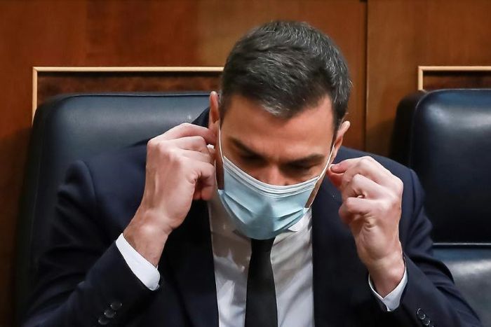 Spanish Prime Minister Pedro Sanchez wears a mask -- his government says it will keep the measure in place until a coronavirus vaccine is found