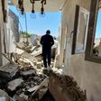 A resident walks through a building damaged by fighting in the Libyan capital Tripoli, on May 1, 2020