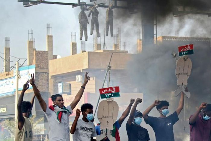 Sudanese protesters hang up effigies depicting Rapid Support Forces soldiers on the first anniversary of a deadly raid on an anti-government sit-in protest