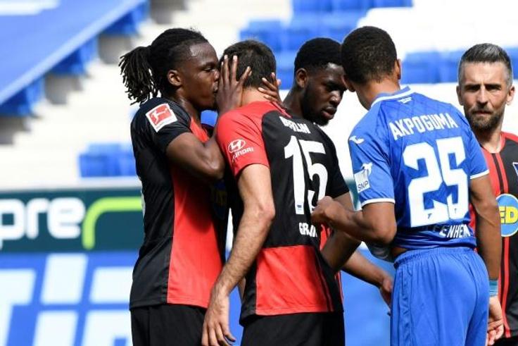 Kiss me quick: Hertha's Dedryck Boyata kisses teammate Marko Grujic