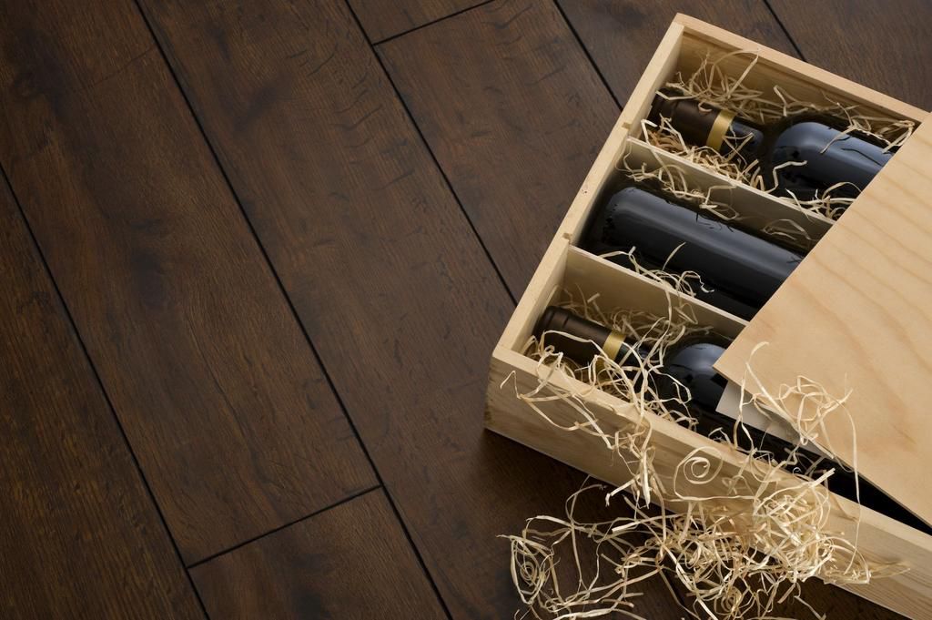 Opened wooden wine box packed with wine and straw