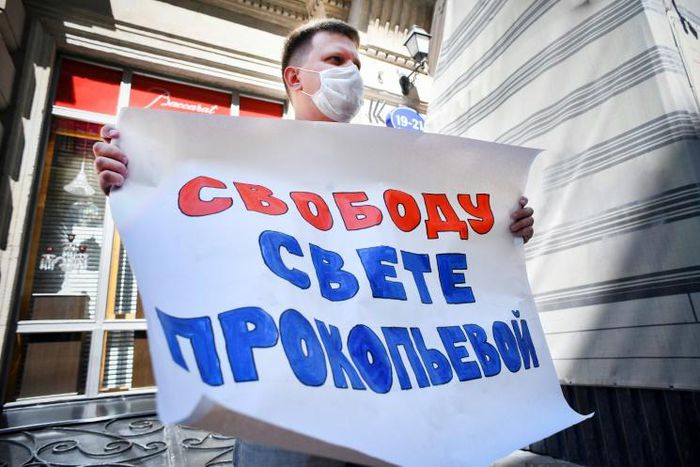 An activist demands 'Freedom for Svetlana' as a Russian court finds journalist Svetlana Prokopyeva guilty of 'justifying terrorism'