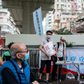 People stand at a booth where passersby can give their signatures in support of a new security law in Hong Kong