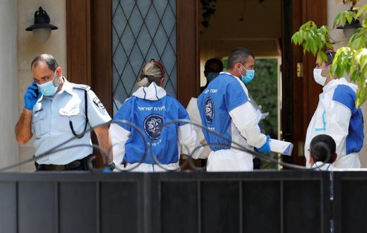 Police and forensic experts gather at the residence of the Chinese ambassador to Israel, Du Wei, on the outskirts of Tel Aviv after he was found dead on Sunday