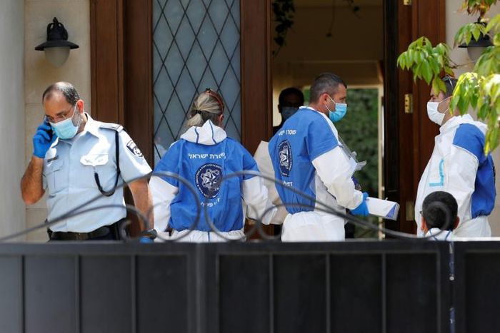 Police and forensic experts gather at the residence of the Chinese ambassador to Israel, Du Wei, on the outskirts of Tel Aviv after he was found dead on Sunday