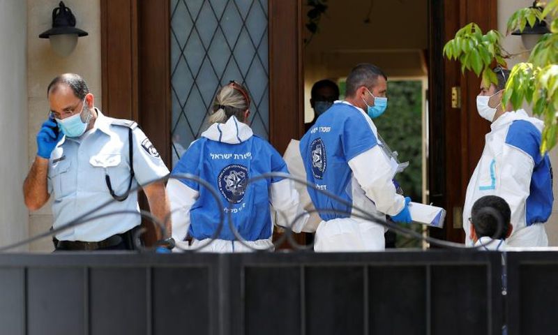 Police and forensic experts gather at the residence of the Chinese ambassador to Israel, Du Wei, on the outskirts of Tel Aviv after he was found dead on Sunday