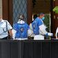 Police and forensic experts gather at the residence of the Chinese ambassador to Israel, Du Wei, on the outskirts of Tel Aviv after he was found dead on Sunday