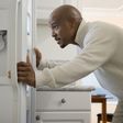African man looking in refrigerator