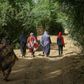Sudanese women walk in the capital Khartoum's district of Jureif Ghar
