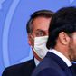 (FILES) In this file photo taken on June 17, 2020 Brazilian President Jair Bolsonaro (L) looks at his newly appointed communications minister, Fabio Faria, at the presidential office in Brasilia.Bolsonaro, backed by his new communications ministry, is ...