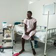 Jonel Cadet, 25, sits in his rehab room at the Doctors Without Borders hospital in Cite Soleil -- if not for his motorcycle accident, he would not have discovered he had COVID-19