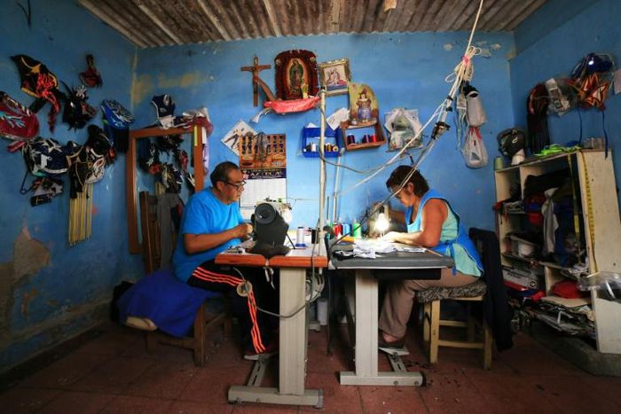 Jose Isaias Huerta (L), a former wrestler, and his wife, Virginia, manufacture lucha libre masks which people are using as face masks in the fight against coronavirus