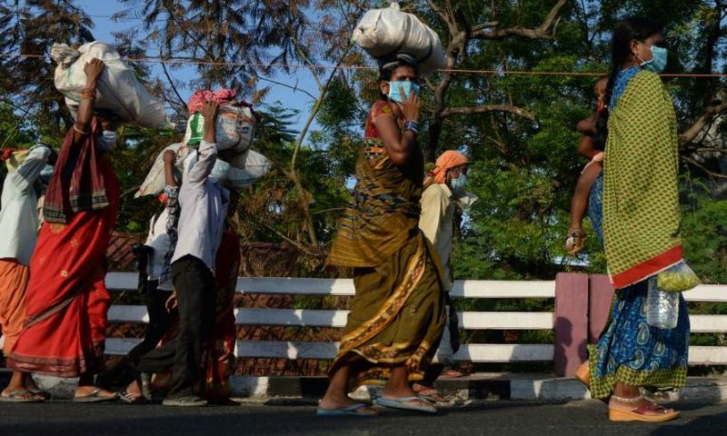 Stranded migrants in Chennai, in southeastern India, prepare to board a special train after the government eased a nationwide coronavirus lockdown
