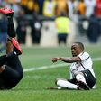George Maluleka (L) of Kaizer Chiefs tumbles after colliding with Mthokozisi Dube (R) of Orlando Pirates in a match between the biggest South African Premiership crowd-pullers