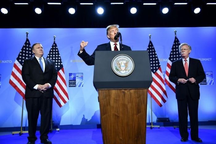 US President Donald Trump is accompanied by US Secretary of State Mike Pompeo (left) and then national security advisor John Bolton (right) at a July 2018 press conference at the NATO headquarters in Brussels