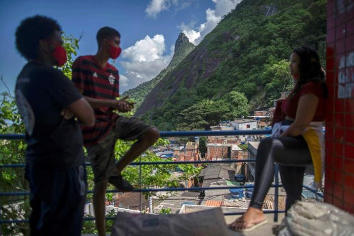 Volunteers wait to help with disinfection at the Santa Marta favela in Rio de Janeiro in April 2020