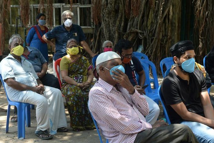 Residents wait to offer a sample for COVID-19 testing in Chennai