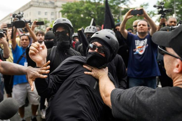 A member of the Antifa group is held back while he argues with a Trump supporter during a rally of right-wing groups in Washington on July 6, 2019.