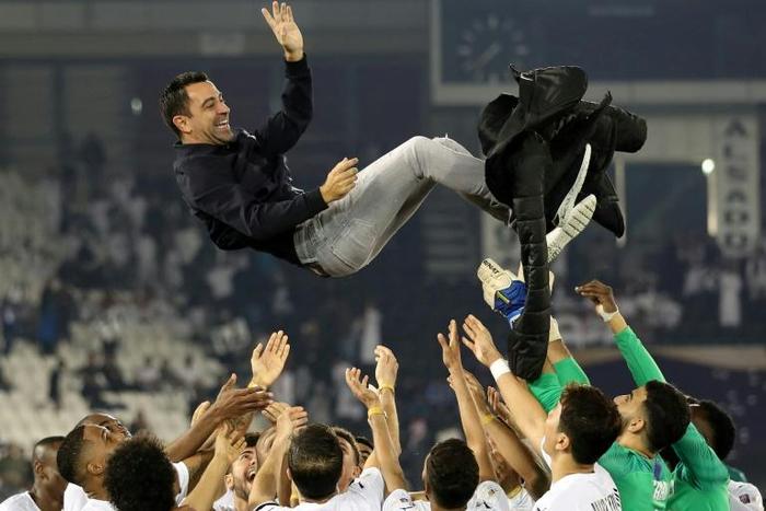Former Barcelona great Xavi Hernandez, who has signed on as coach of Qatari club Al-Sadd for one more year, is thrown in the air after leading the side to victory in the 2020 Qatar Cup