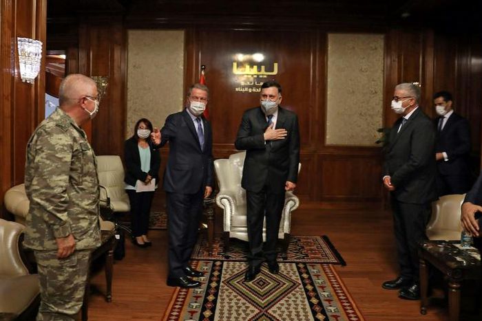 The head of Libya's UN-recognised government Fayez al-Sarraj (C-R) receives Turkish Defence Minister Hulusi Akar (C-L), in the Libyan capital Tripoli on July 3, 2020