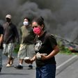 People take part in a protest against the burial of COVID-19 victims near their communities on the Tegucigalpa-Olancho highway
