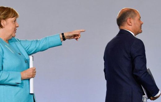 German Chancellor Angela Merkel points to Finance Minister Olaf Scholz after announcing the new stimulus package
