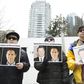 Protesters in Vancouver hold photos of Michael Spavor and Michael Kovrig. The pair have now been held in detention in China for more than 500 days