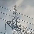 Pastor climbs high tension electricity pole and threatens to jump to death (video)