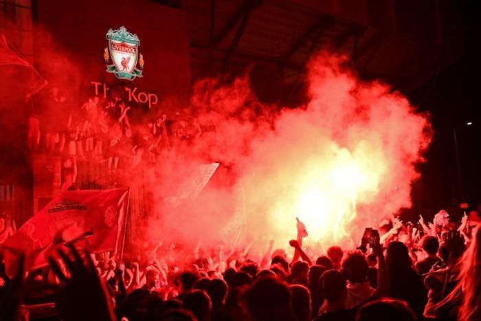 Liverpool fans celebrate the club's first league title in 30 years outside Anfield