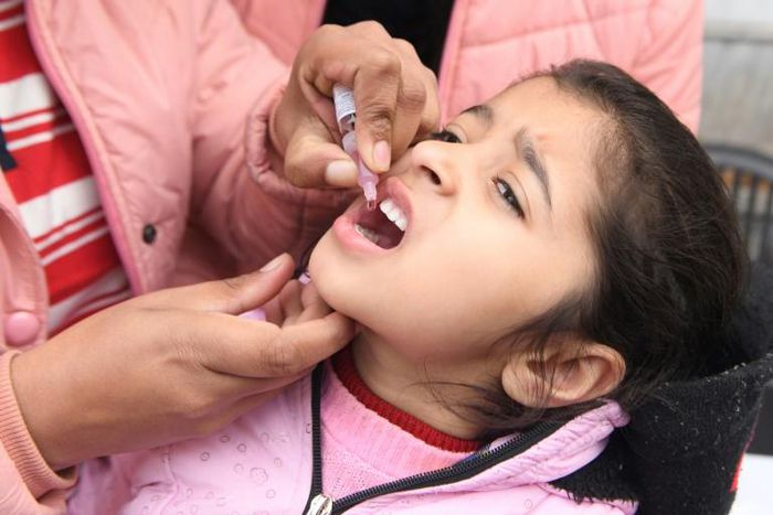Health workers administer polio drops to a child in the Indian city of Amritsar in January 2020