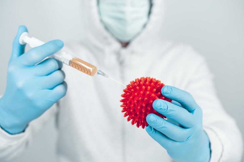 Close-Up Of Gloved Hands Holding Syringe And Virus Representation