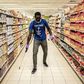 A man disinfects an empty supermarket in Dakar