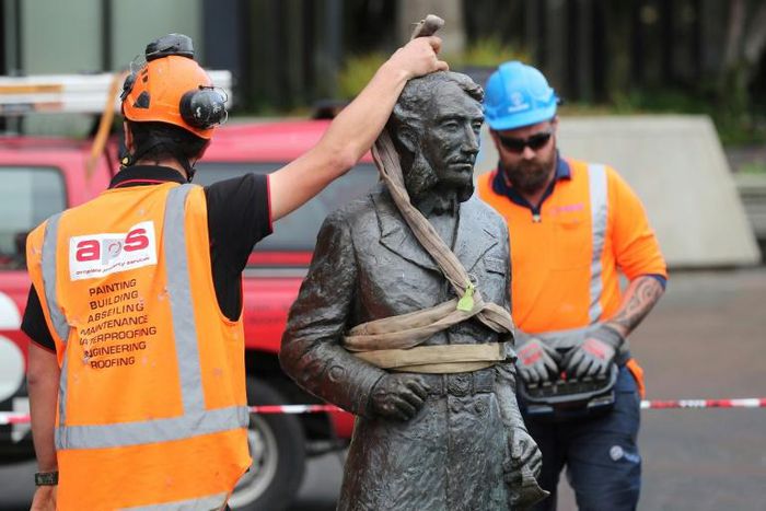 A crane hoists the sculpture of Captain John Fane Charles Hamilton from the city square after requests from Maori and threats from anti-racism protesters to topple it